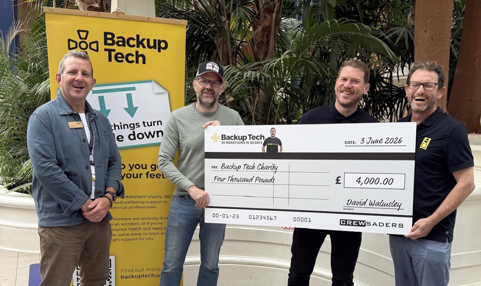 David Walmsley presents a £4,000 cheque to Lee Dennison of Backup Tech alongside Crewsaders Managing Director Jez Berryman at the ABTT Theatre Show