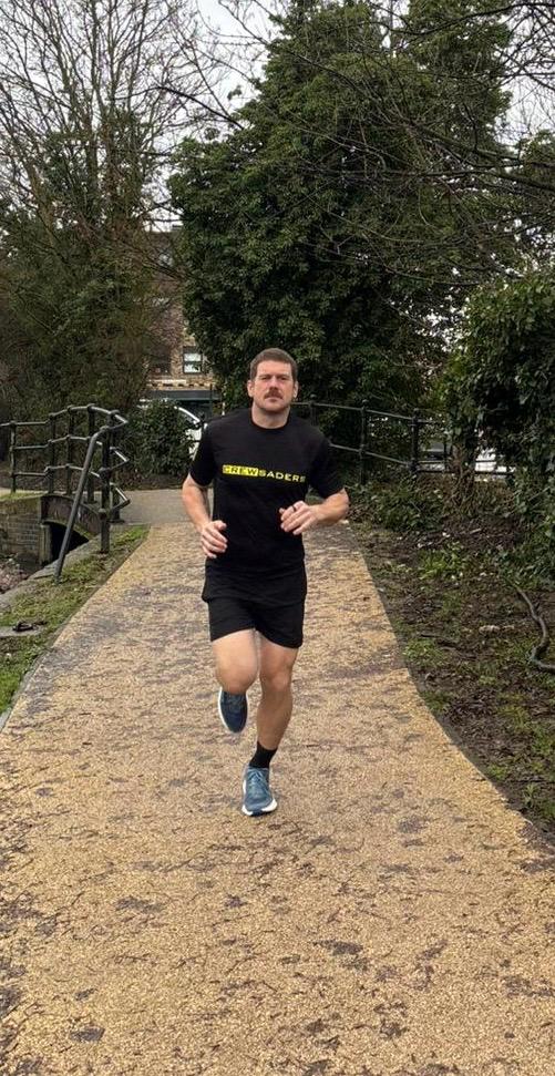 David running through a park in his Crewsaders kit